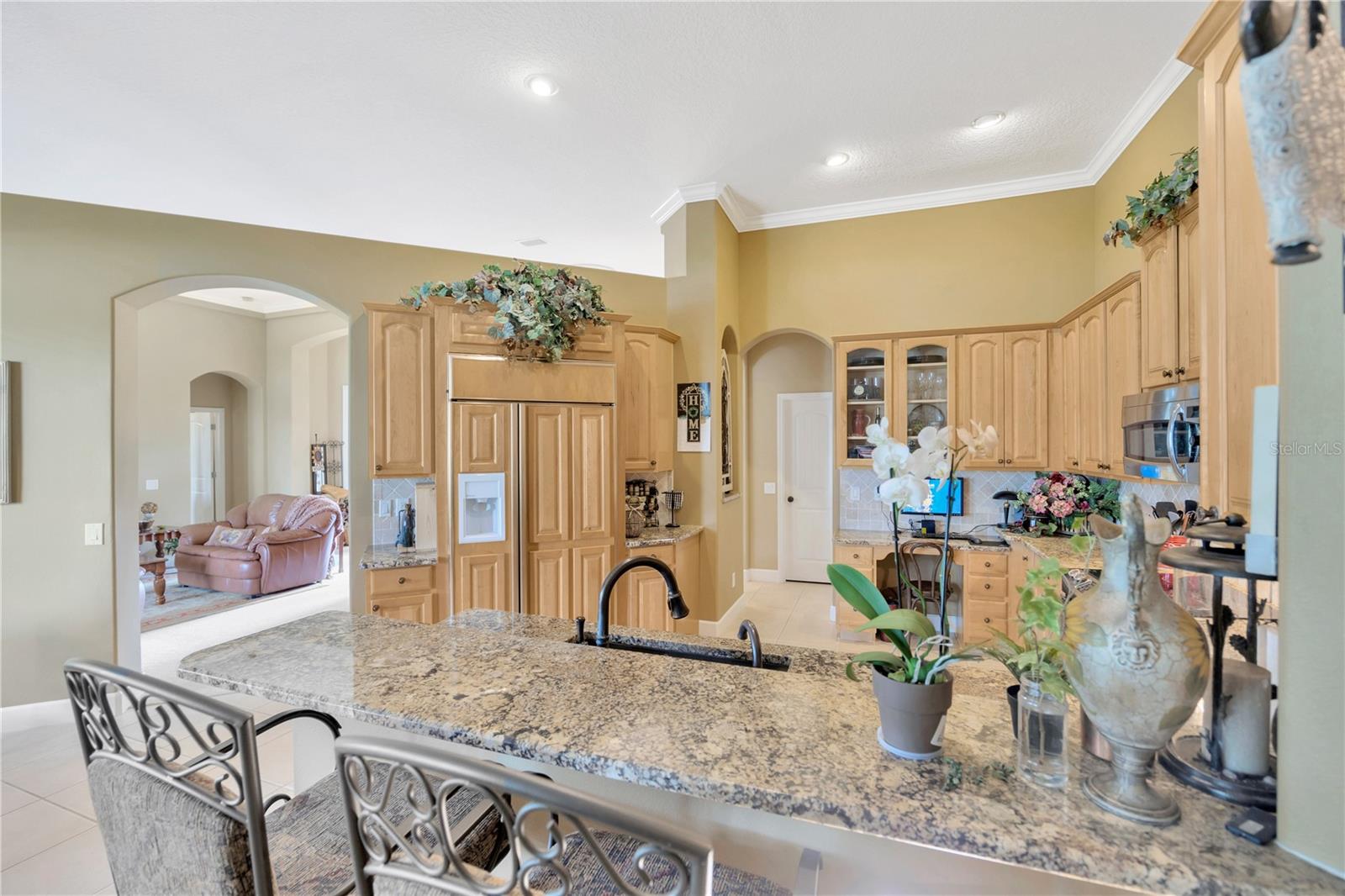 Kitchen with breakfast bar, view from family room