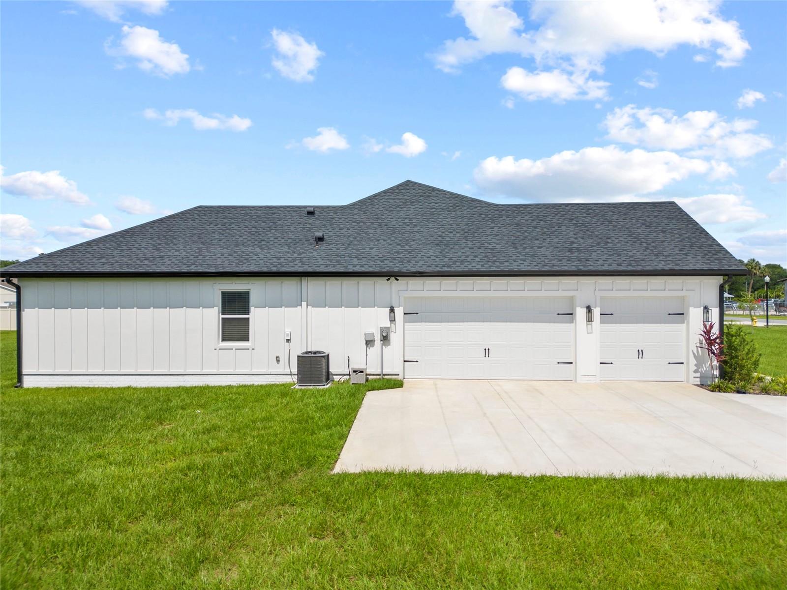 oversized 3 car garage + additional parking pad for additional vehicles