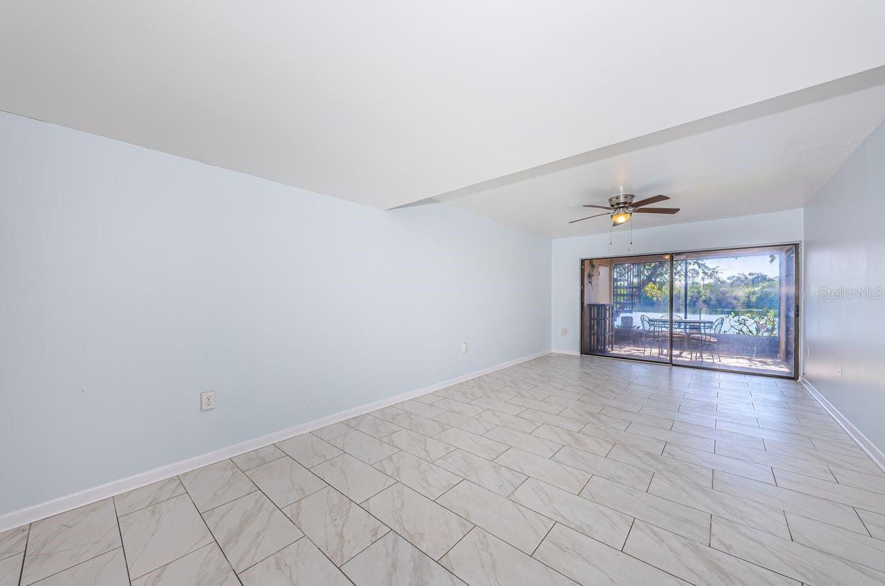 Living room sliders open to screened porch and the outdoors.