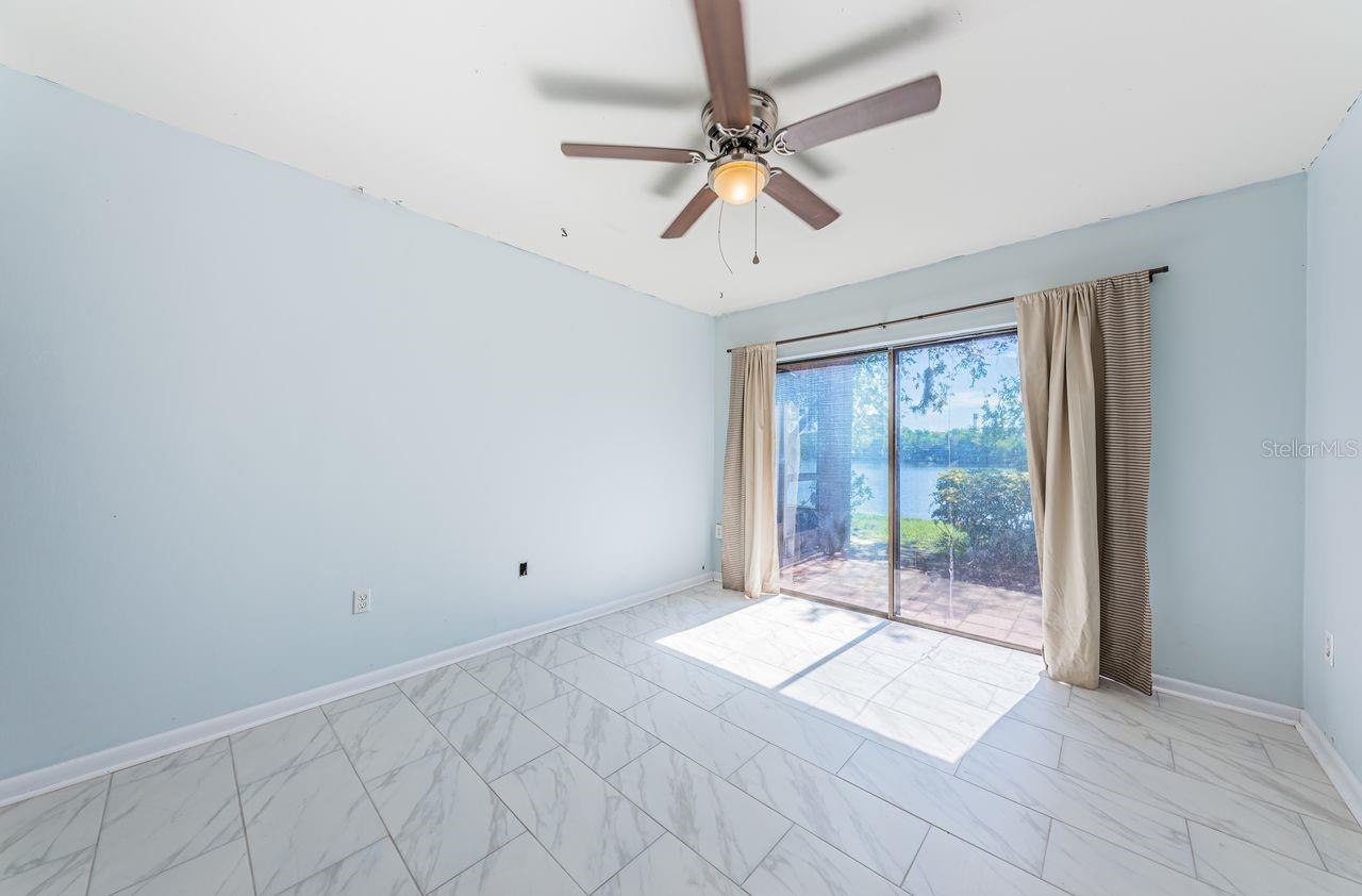 Second bedroom opens to patio and lake view.