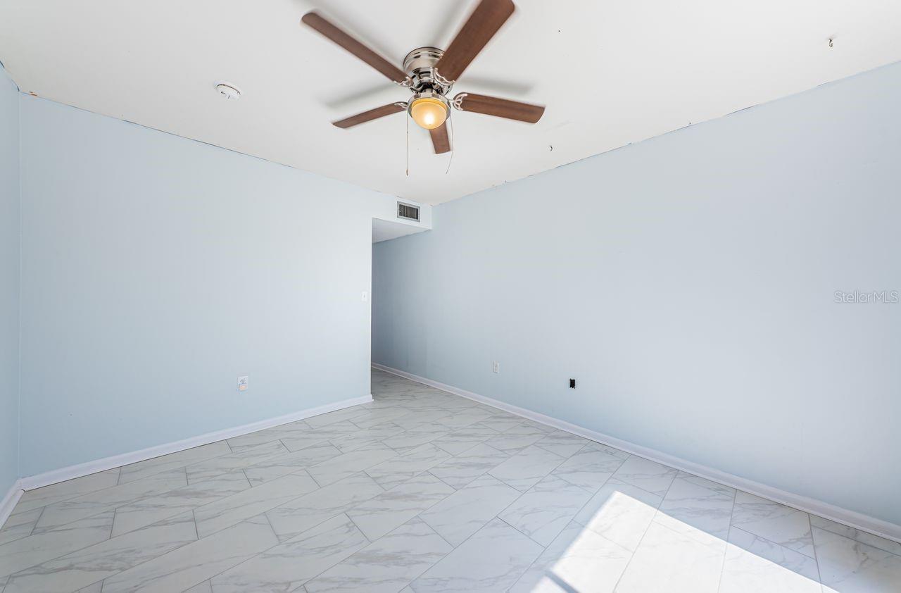 Third bedroom with views of parking lot and across from the pool area.