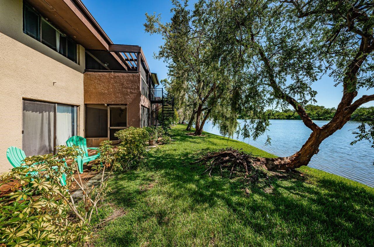 Master bedroom offers sliders to rear of property and stunning view of the lake.