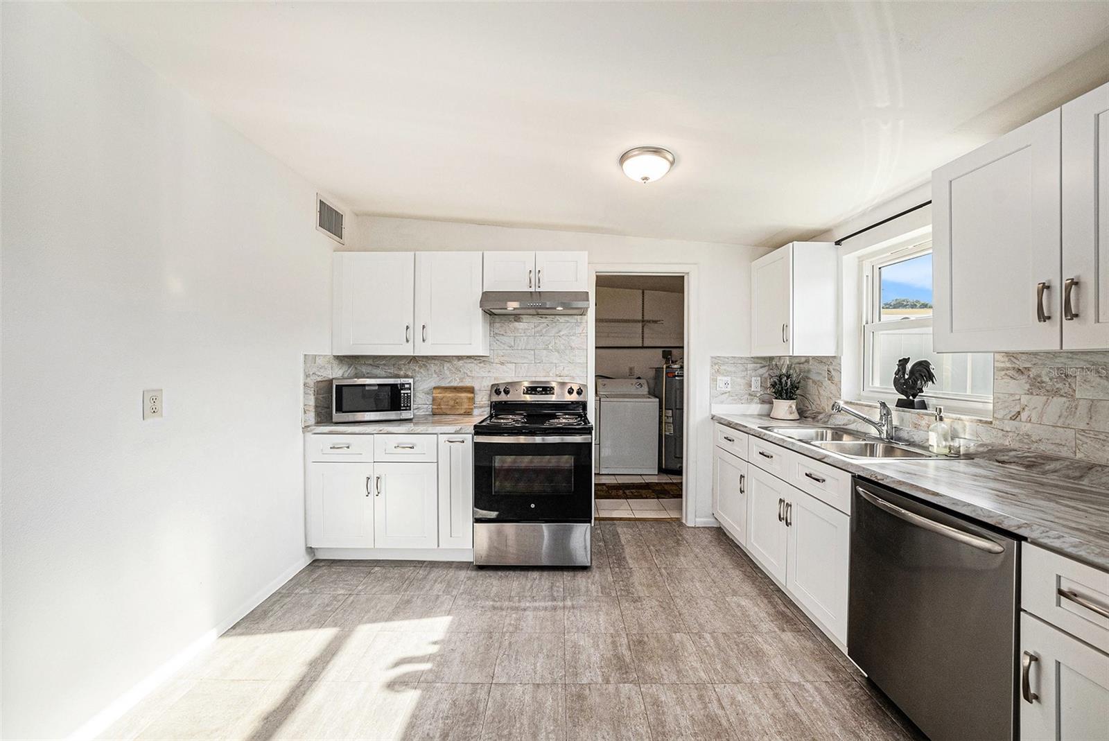 From kitchen to laundry. There is a door to close if off when you want too.