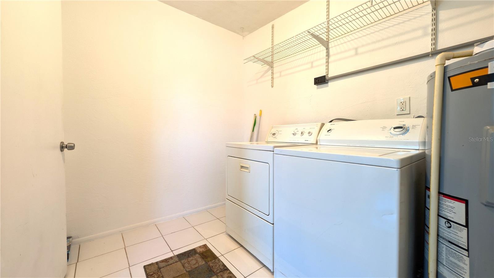 Nice size laundry and storage room.
