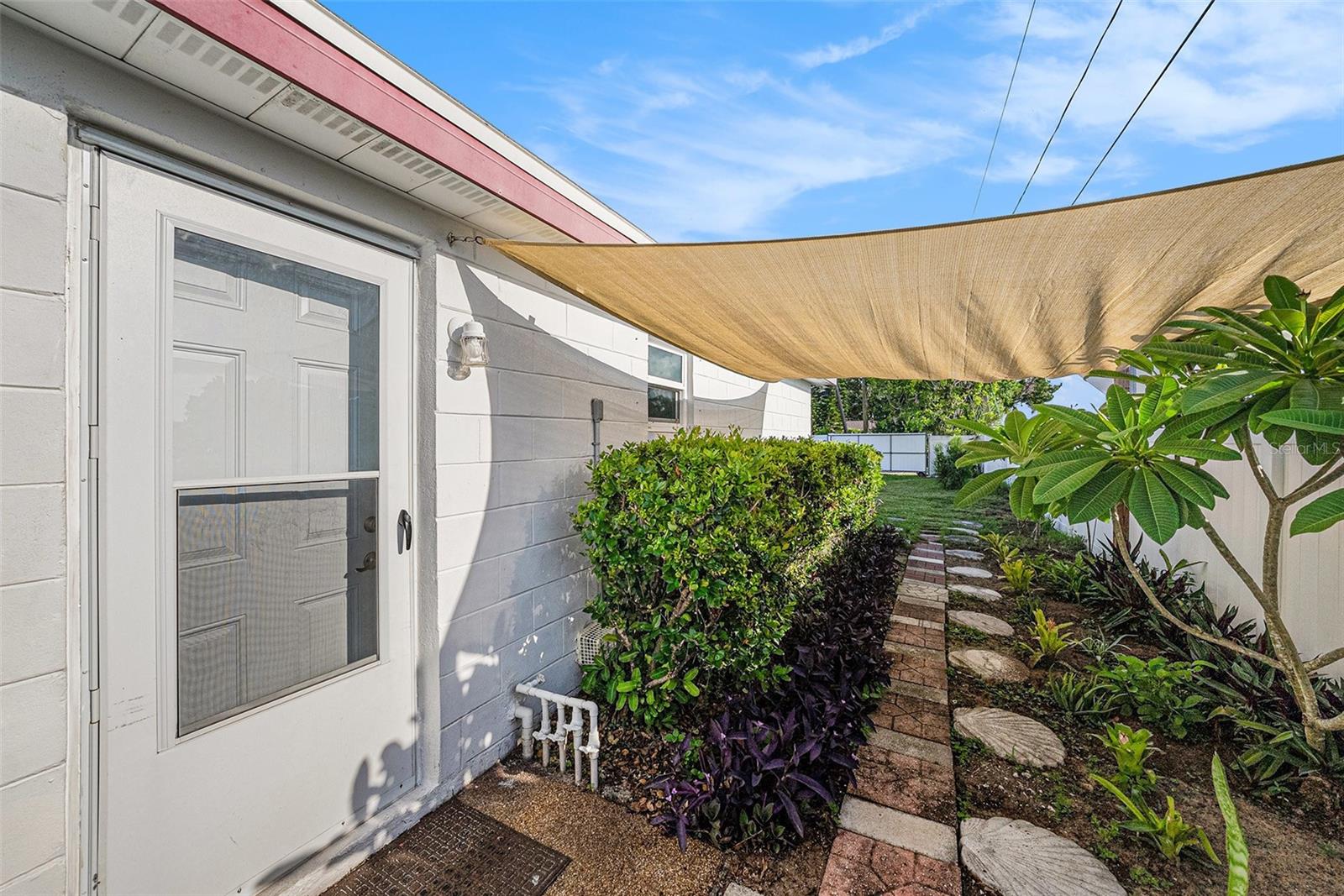 From the laundry room the side entry/exit leads to spacious backyard.