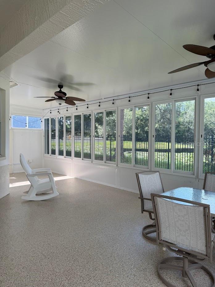 Large sunroom with view of pond