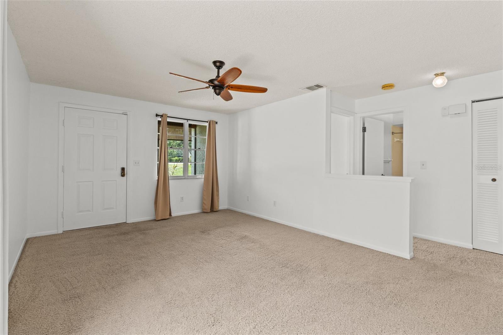 View of front door from entry to kitchen