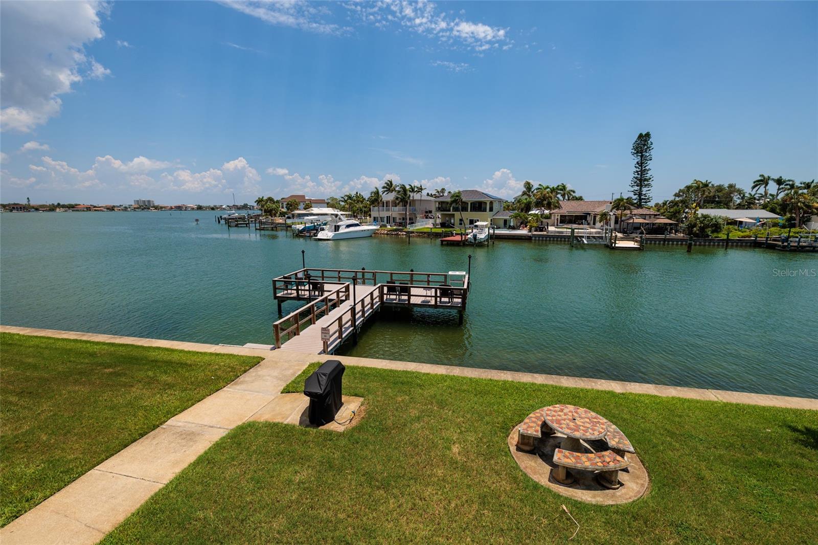 Florida Room views of grilling area, dock & Boca Ciega Bay.