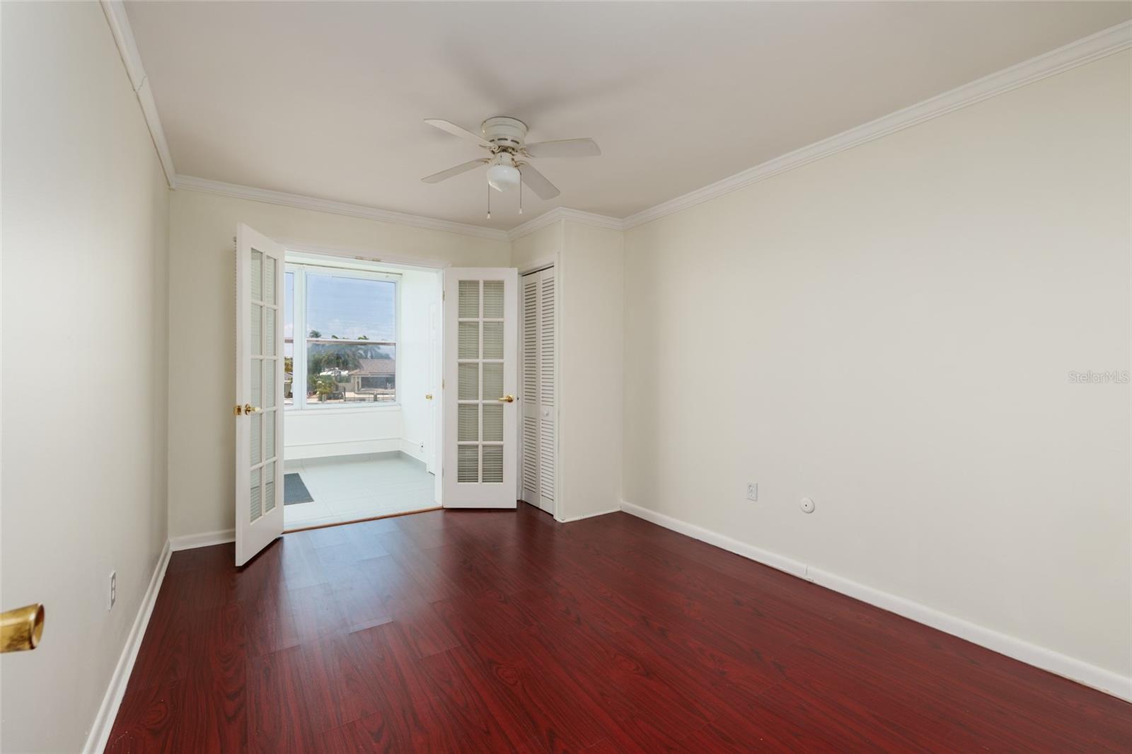2nd Bedroom: 10' x 13'. Water views, French doors to Florida room. 2 closets.