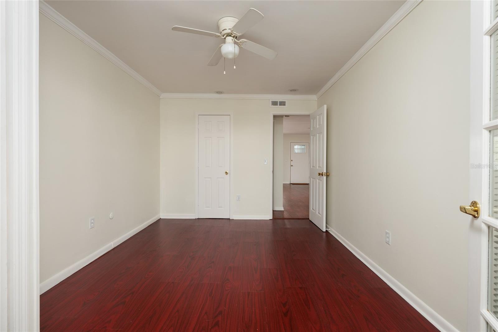 2nd Bedroom: 2 closets (1 with exhaust fan & outlet), Crown molding. Laminate flooring. 10' x 13'.
