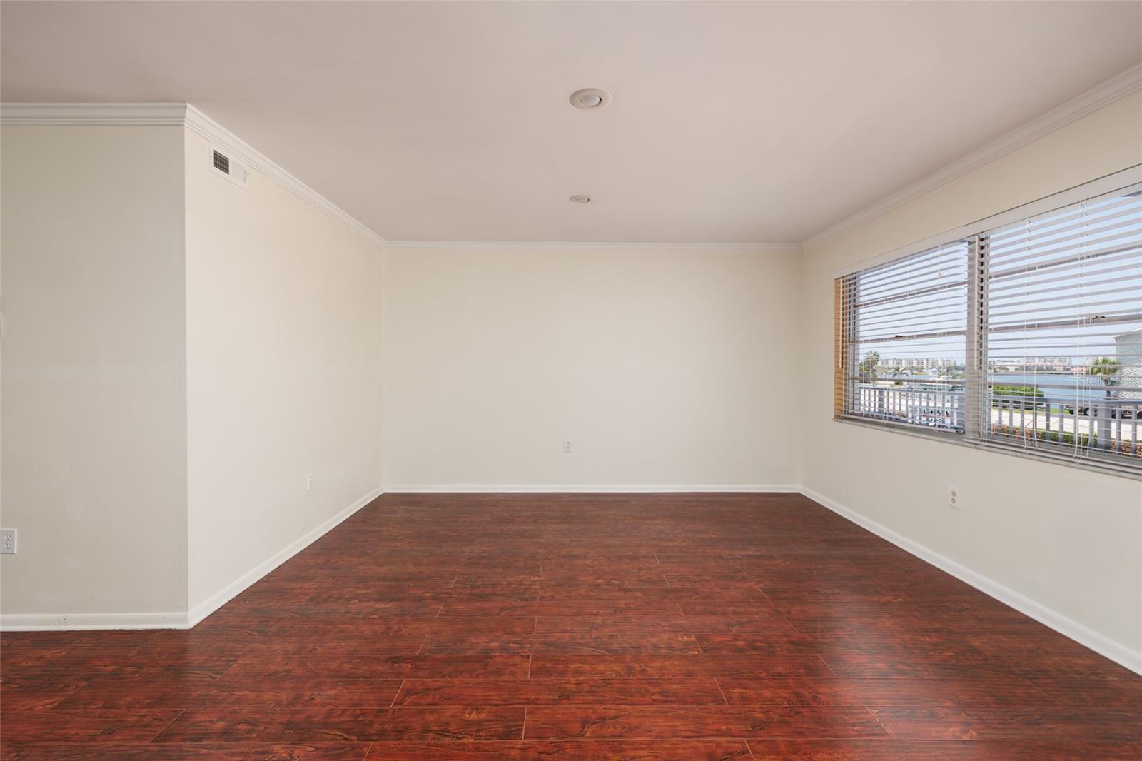 Living Room w/Crown Molding, recessed lighting & Bay views. 18' x 13'.