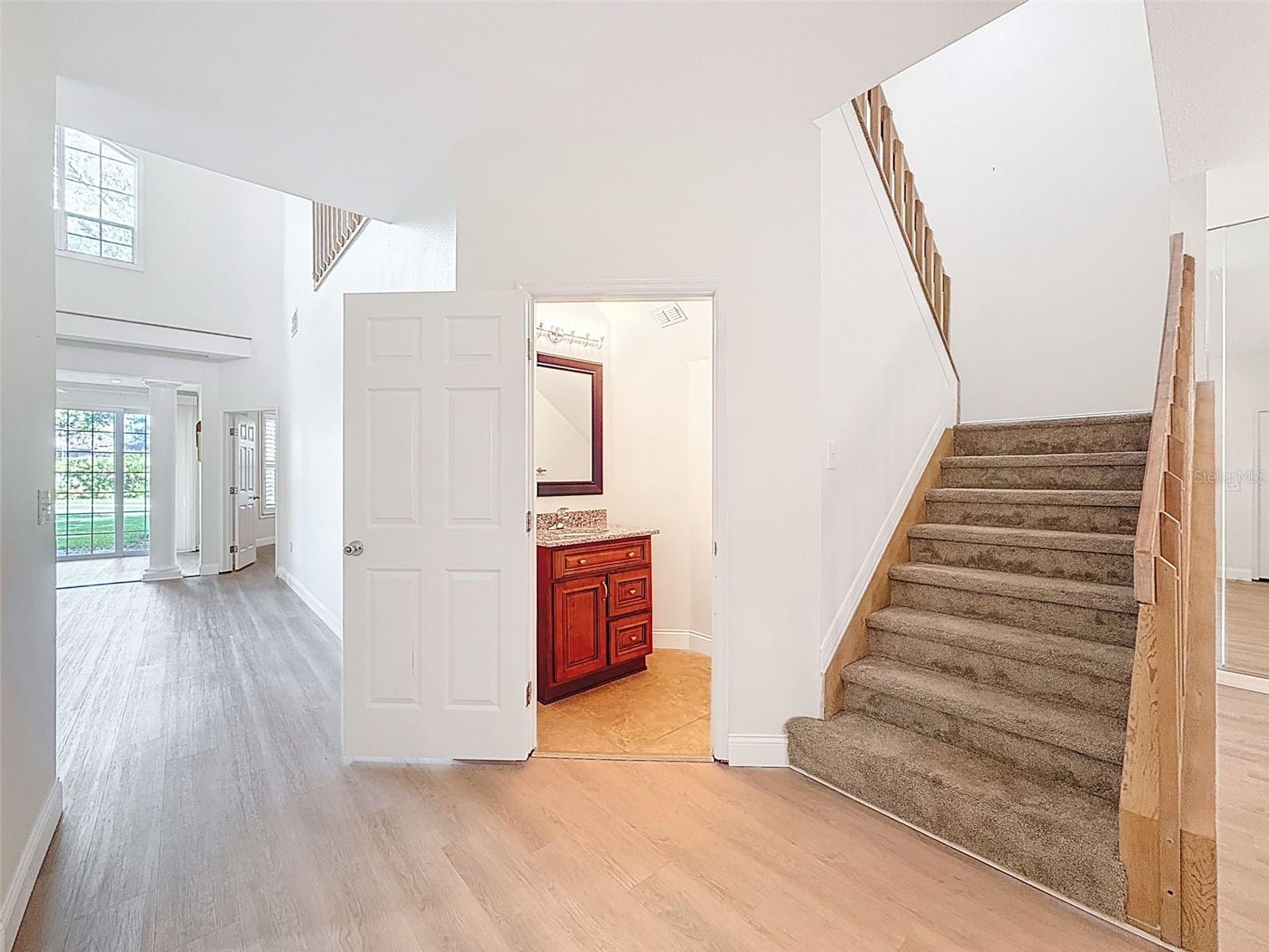 Half bath downstairs and stairs to the second floor