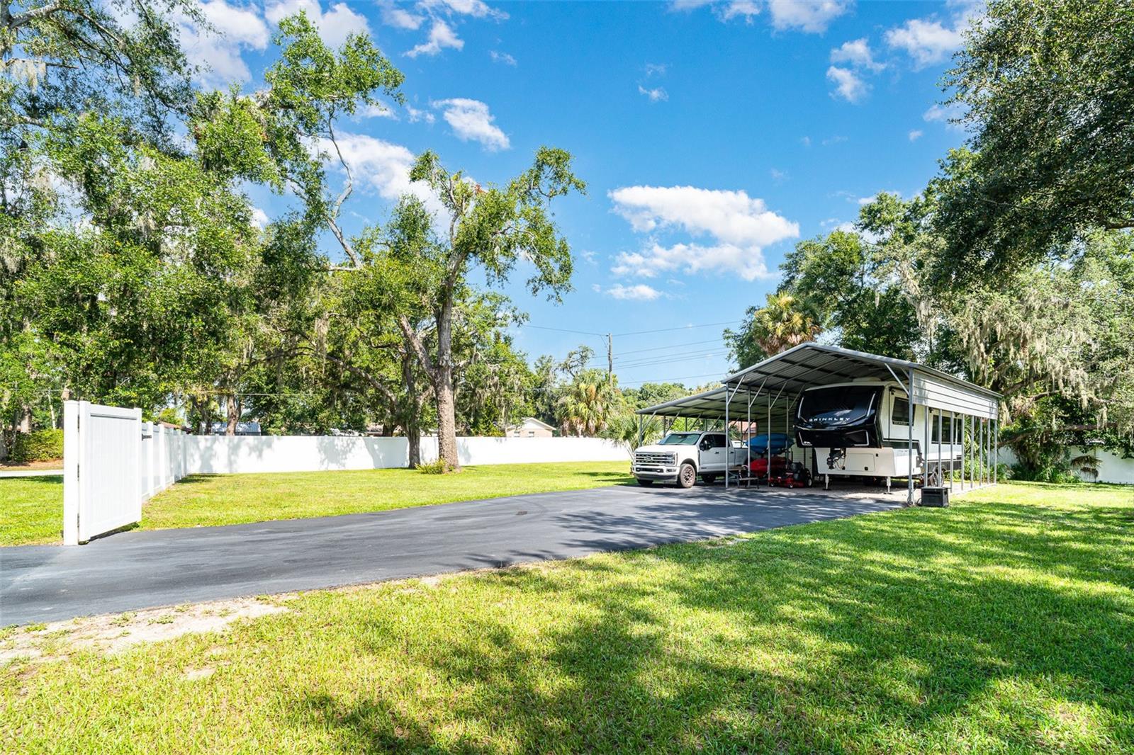 Paved and covered RV/Boat parking with storage shed