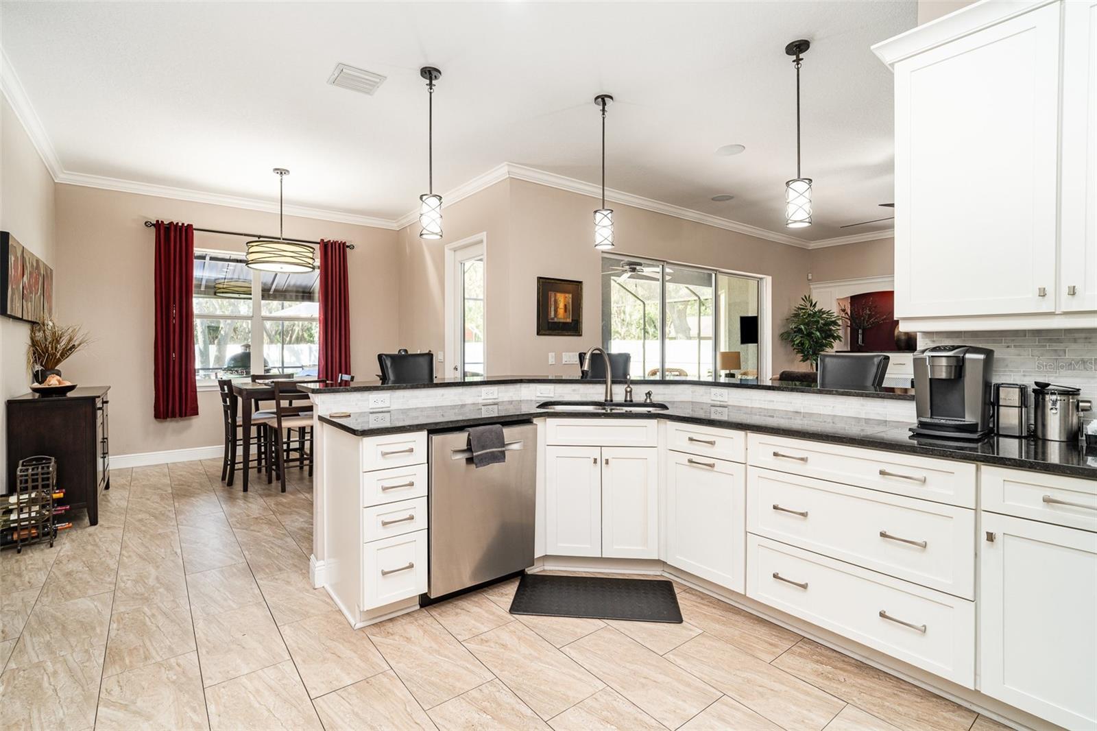 Open kitchen overlooks breakfast area and pool