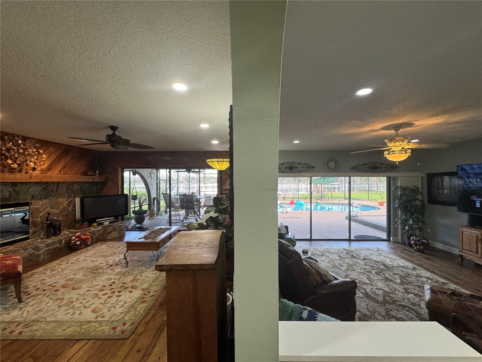 Family rooom on left & living room on right of wall.  Views off private pool & lake along entire back of house from inside.