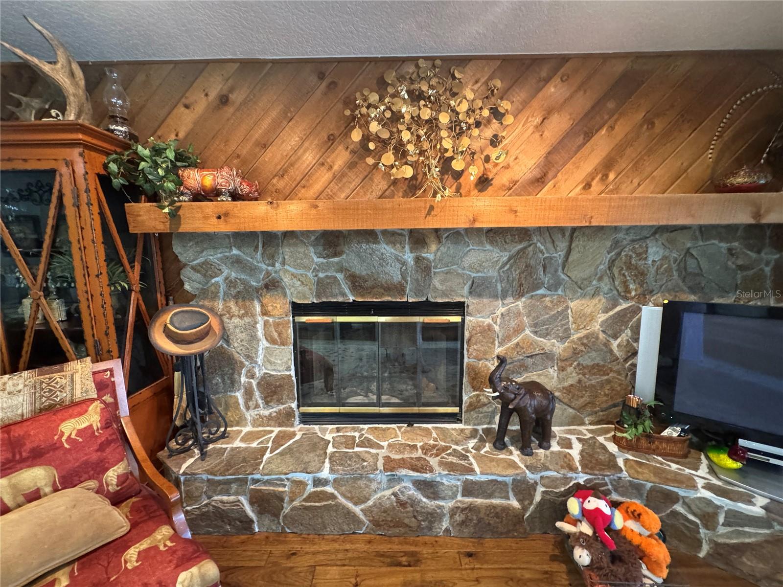 Family room with wood burning fireplace and cedar planks