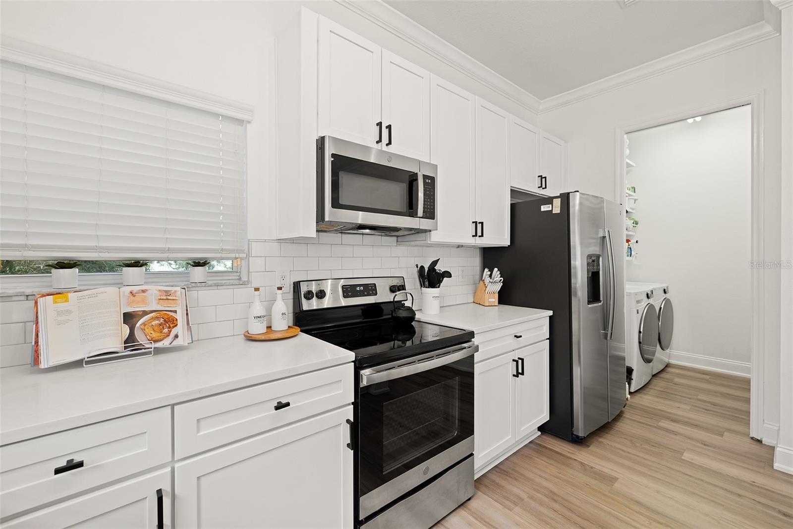 Modern kitchen features stainless steel appliances