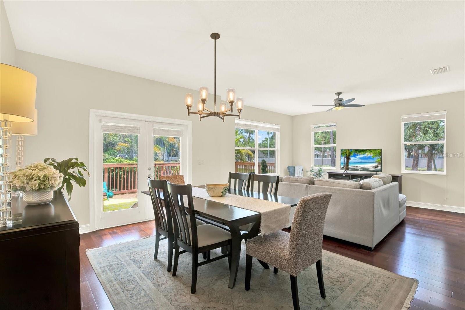 Dining room leading to patio deck, open concept to living and kitchen