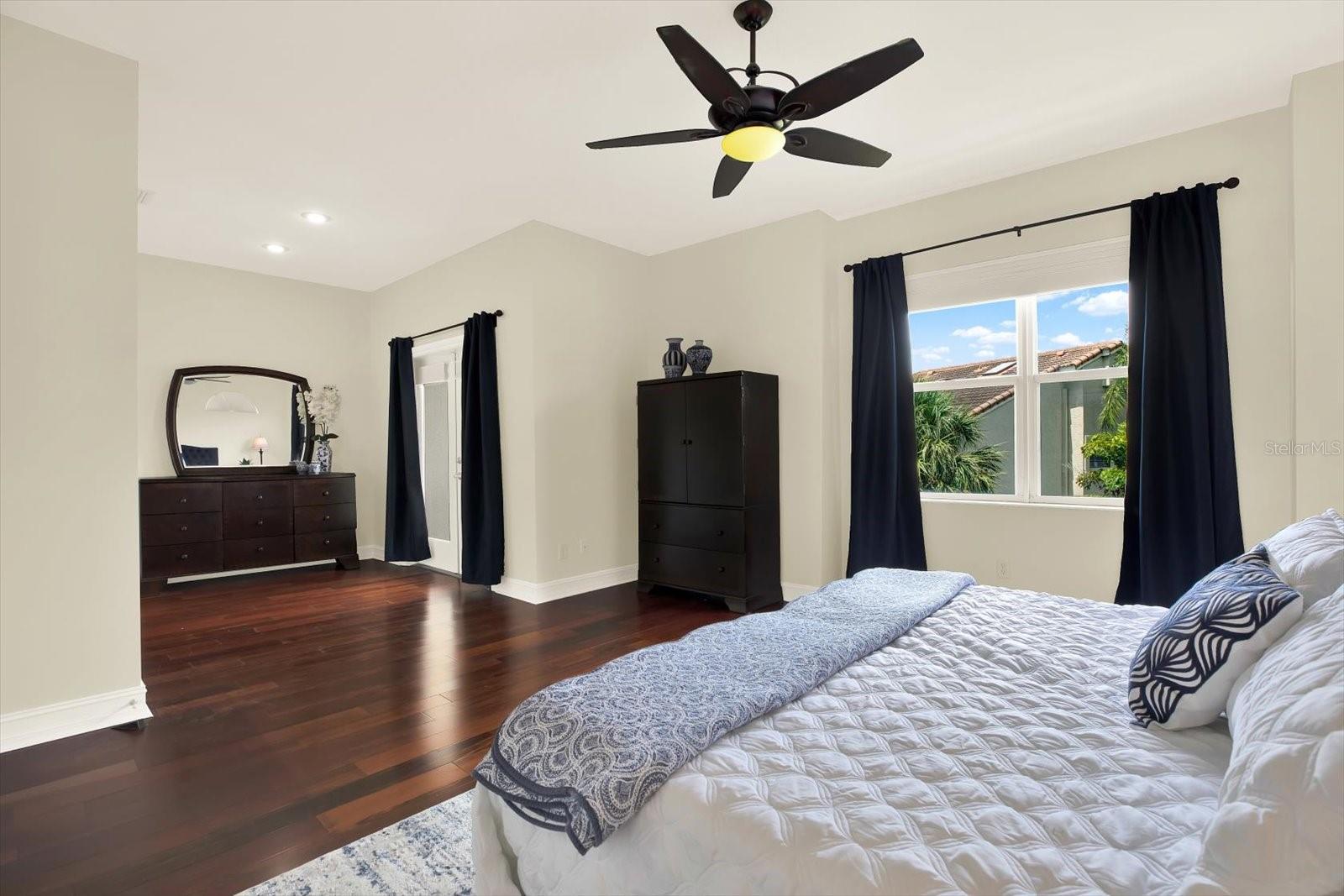 Expansive Primary Suite leading out to private balcony with water view.
