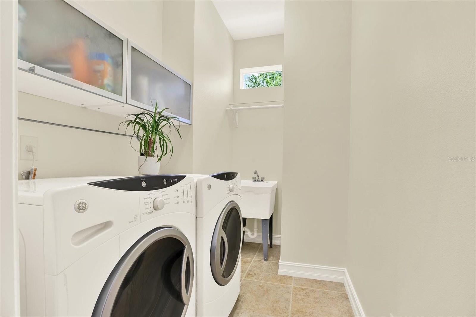 Laundry room with washer, dryer and wash sink.