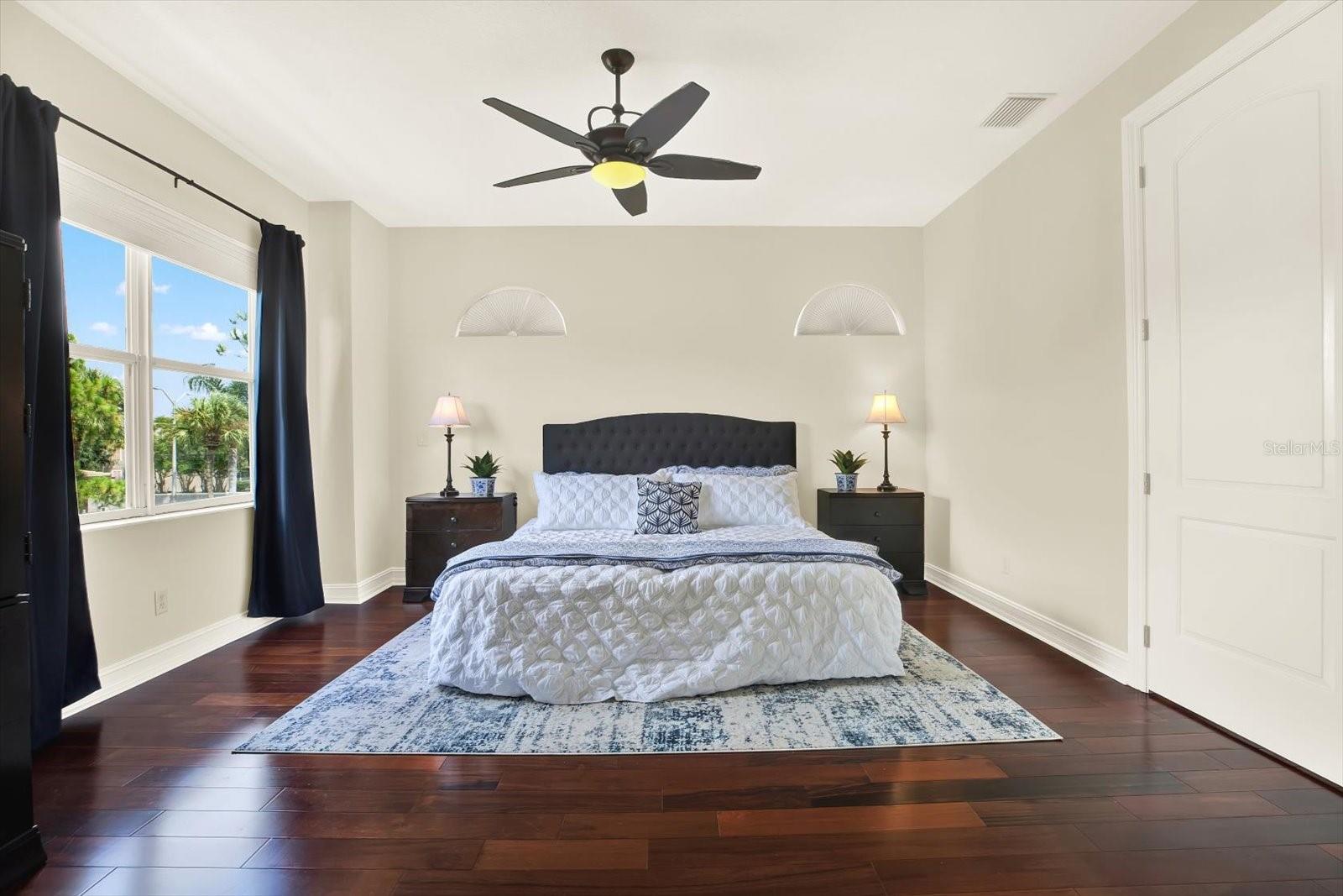 Large Primary Suite with balcony and water view.