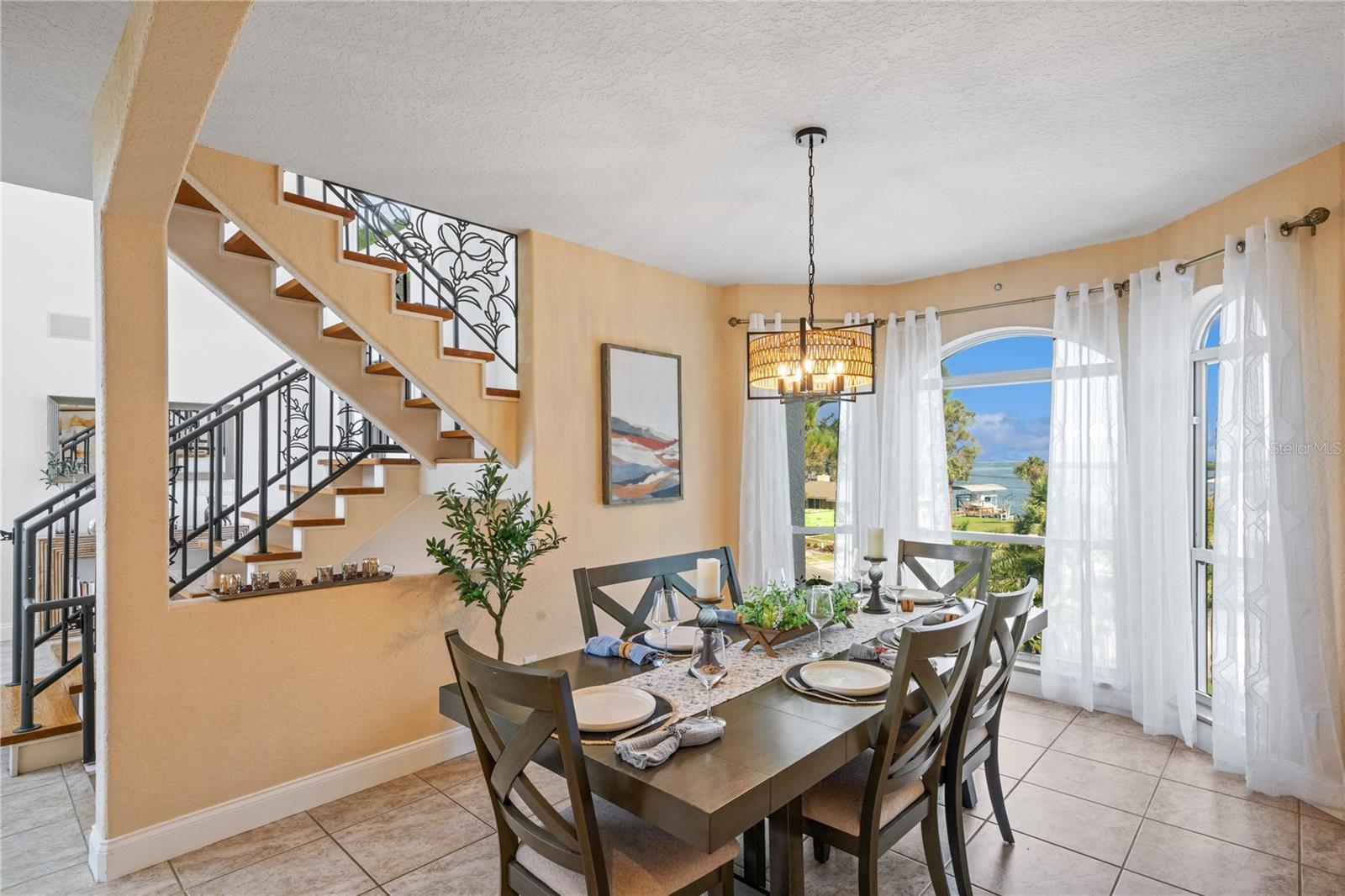 formal dinning room next to floating stairs