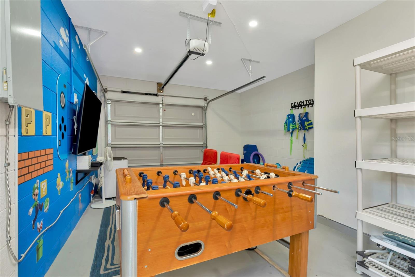 Single car garage which is used as a game room and laundry room.