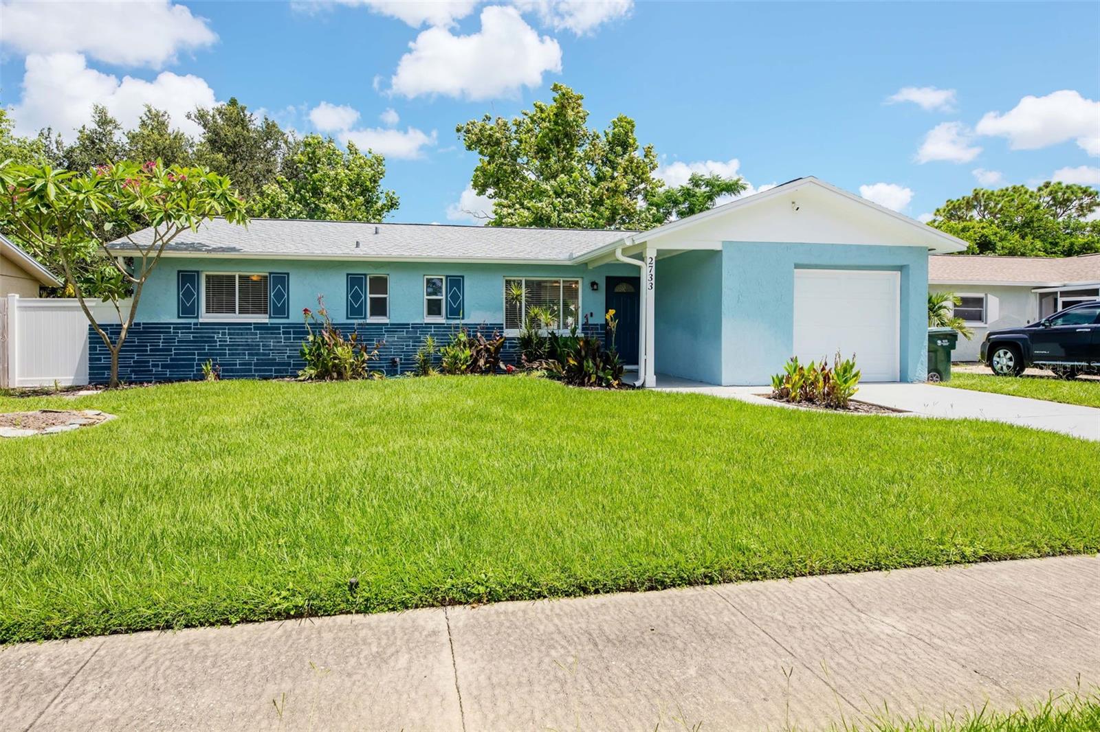 Front of the house and view of the garage.