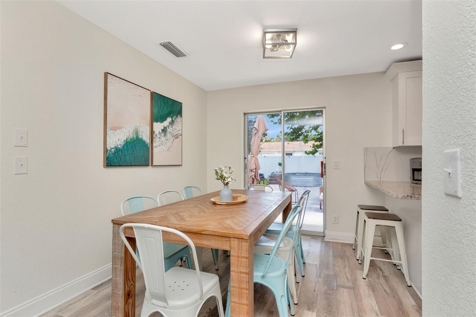 View into the backyard from dining room and breakfast bar in the kitchen.