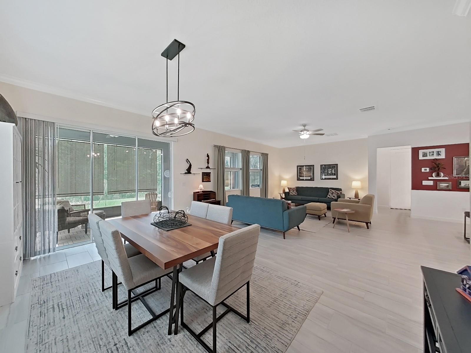 Dining area and Living Room.  Sliding glass doors leading out to patio.  (Dining Area light does not convey)