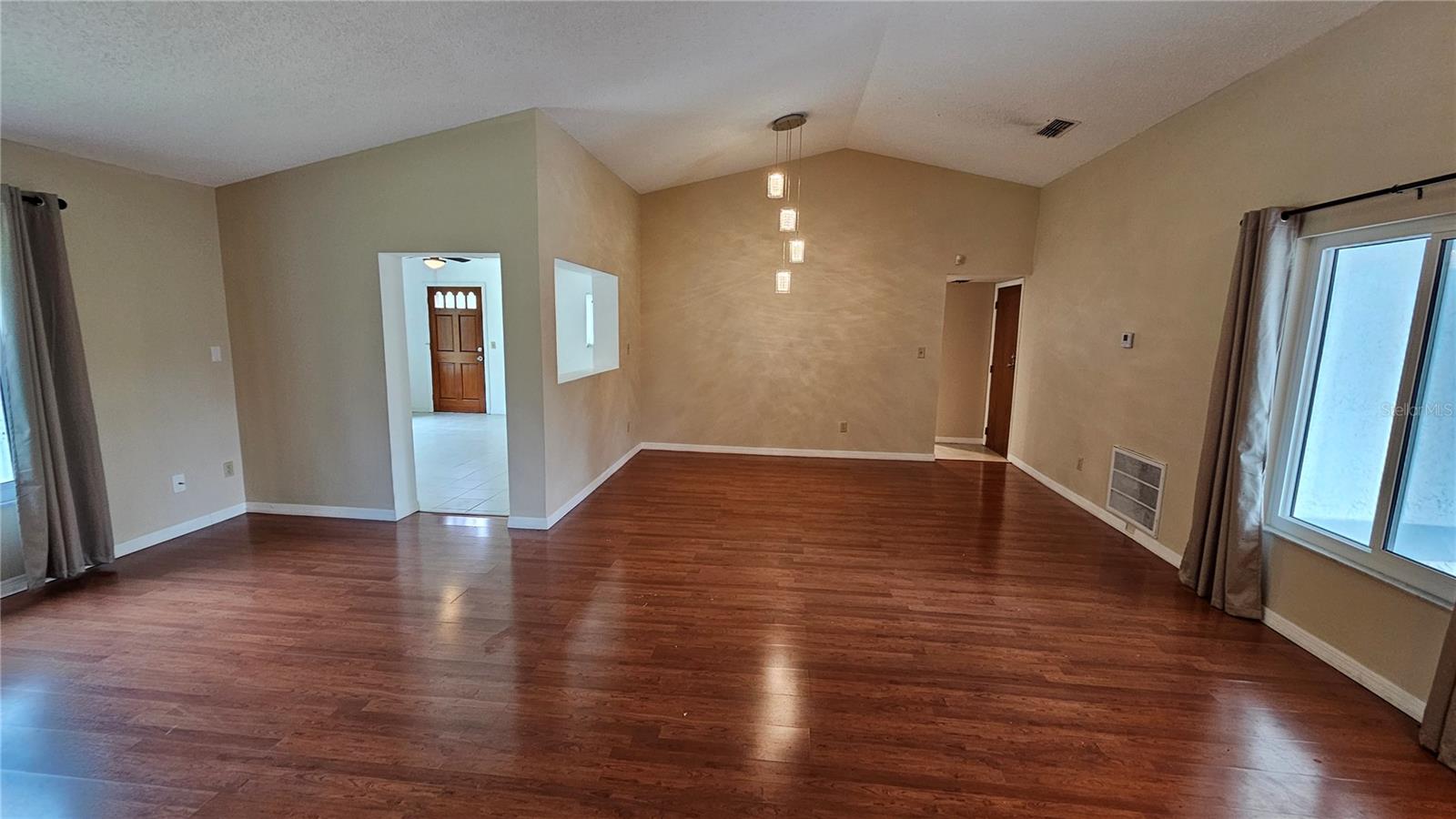 Living room & formal dining room toward rear of photo