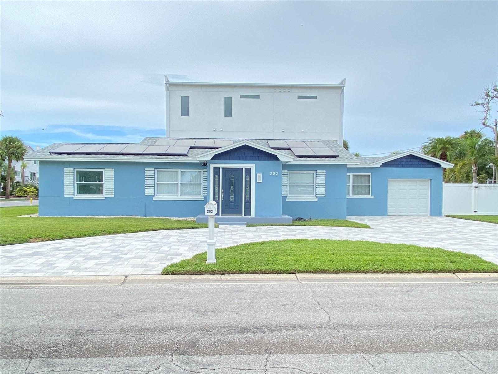 Front of house with circular paver driveway