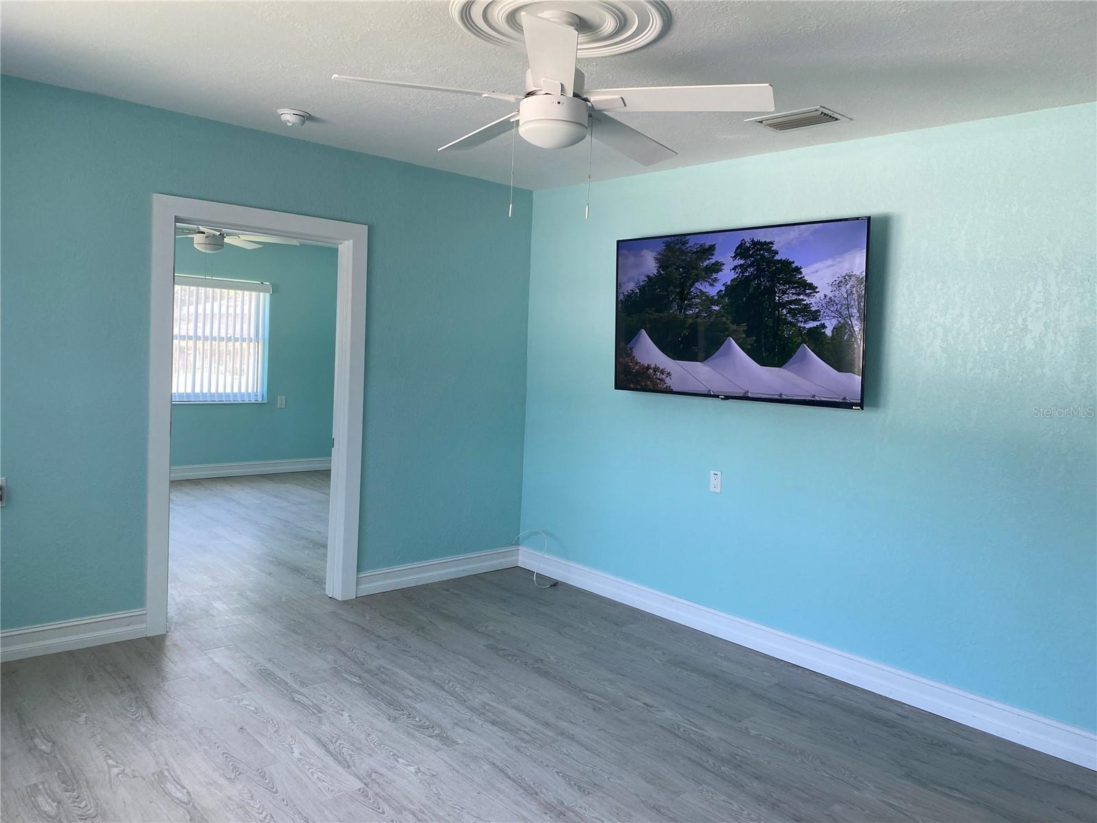 Living room with 65" TV offered.
