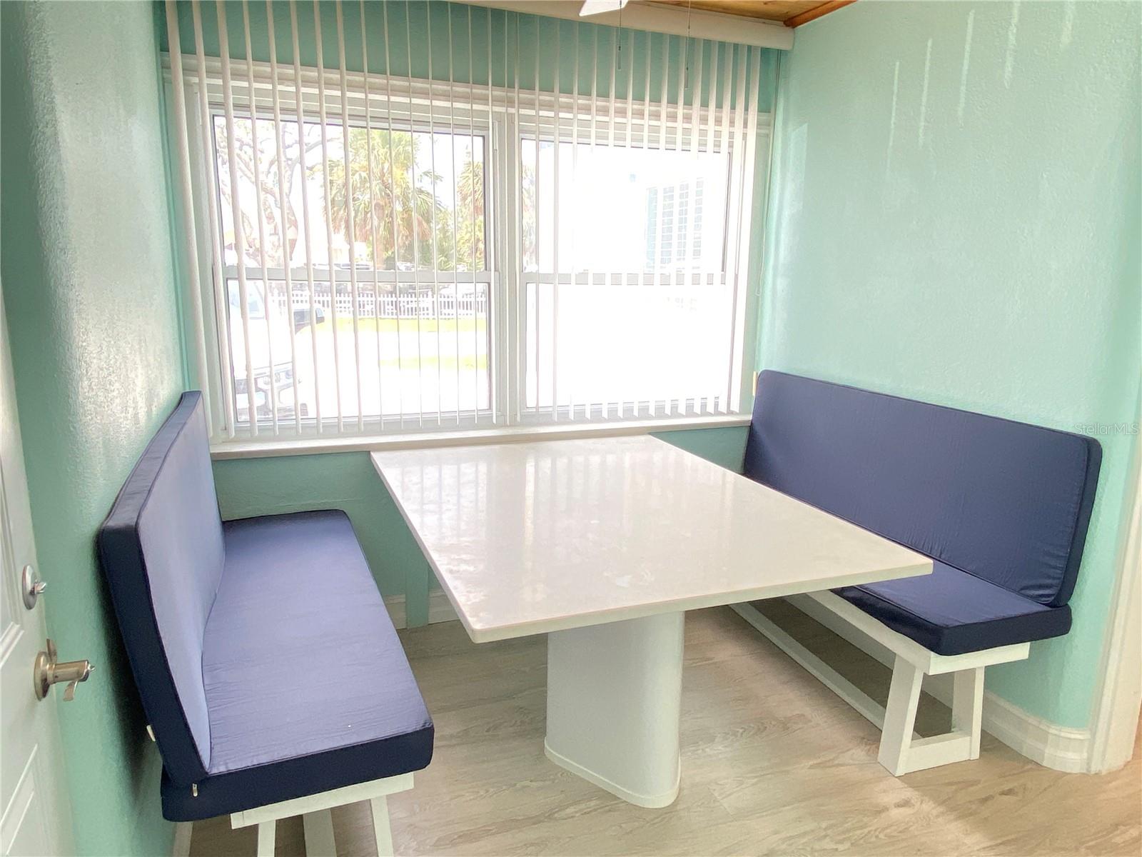 Convenient dinette with quartz table and benches.