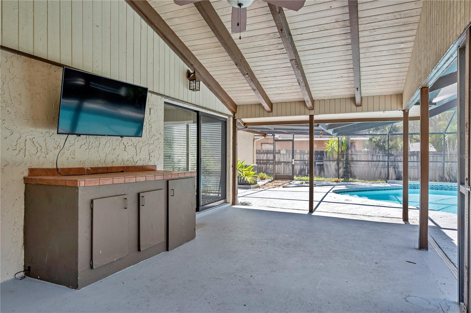Covered Porch with cabinetry for storage