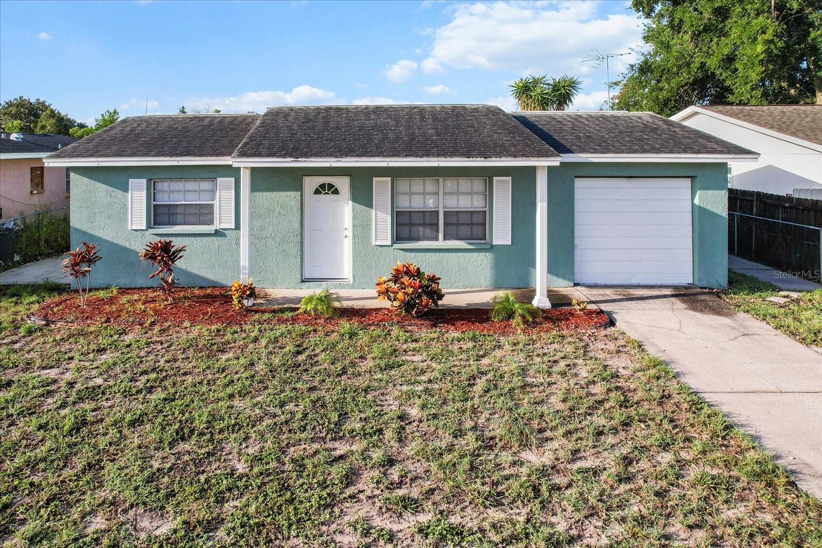 Welcoming curb appeal with a mulched front yard and charming front porch.