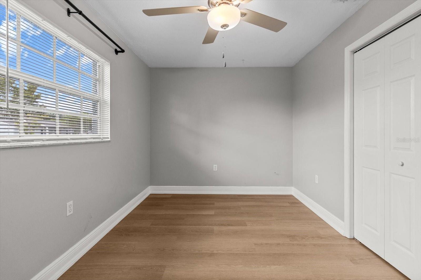 Bedroom 2 Front-facing bedroom with natural light, closet space, and a ceiling fa, ideal for guests, an office, or a relaxing retreat
