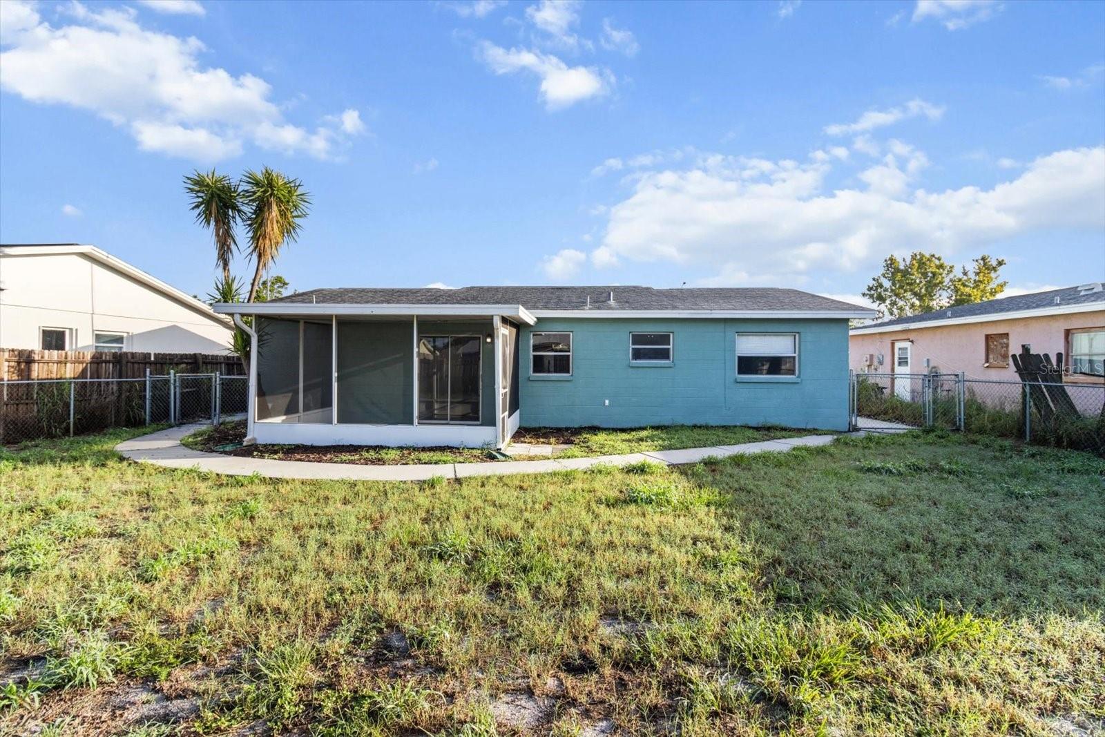 A fully fenced yard framed by a concrete path—ideal for easy maintenance and everyday enjoyment.