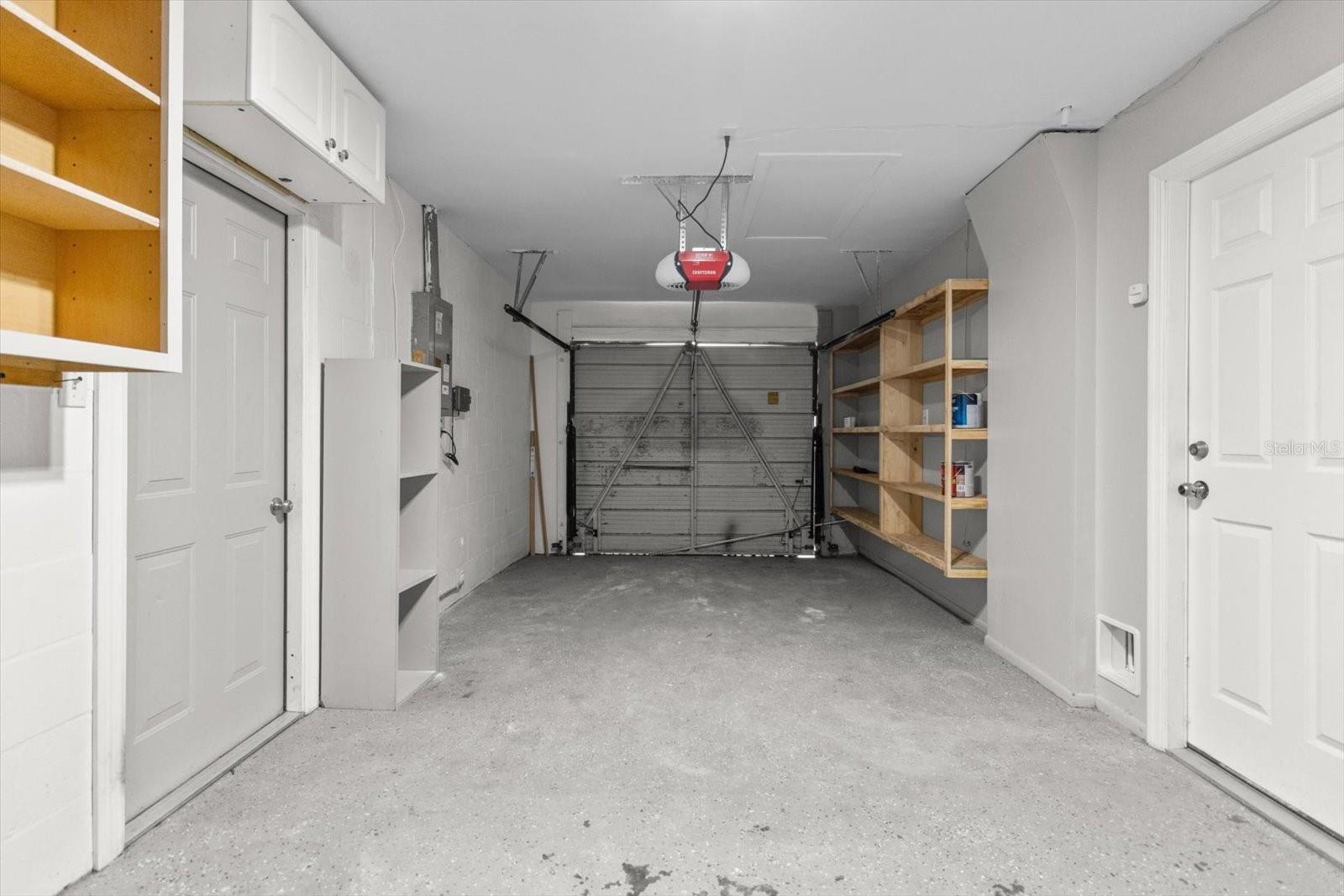 One-car garage with access to both the side yard and interior of the home, offering convenience, security, and extra storage potential