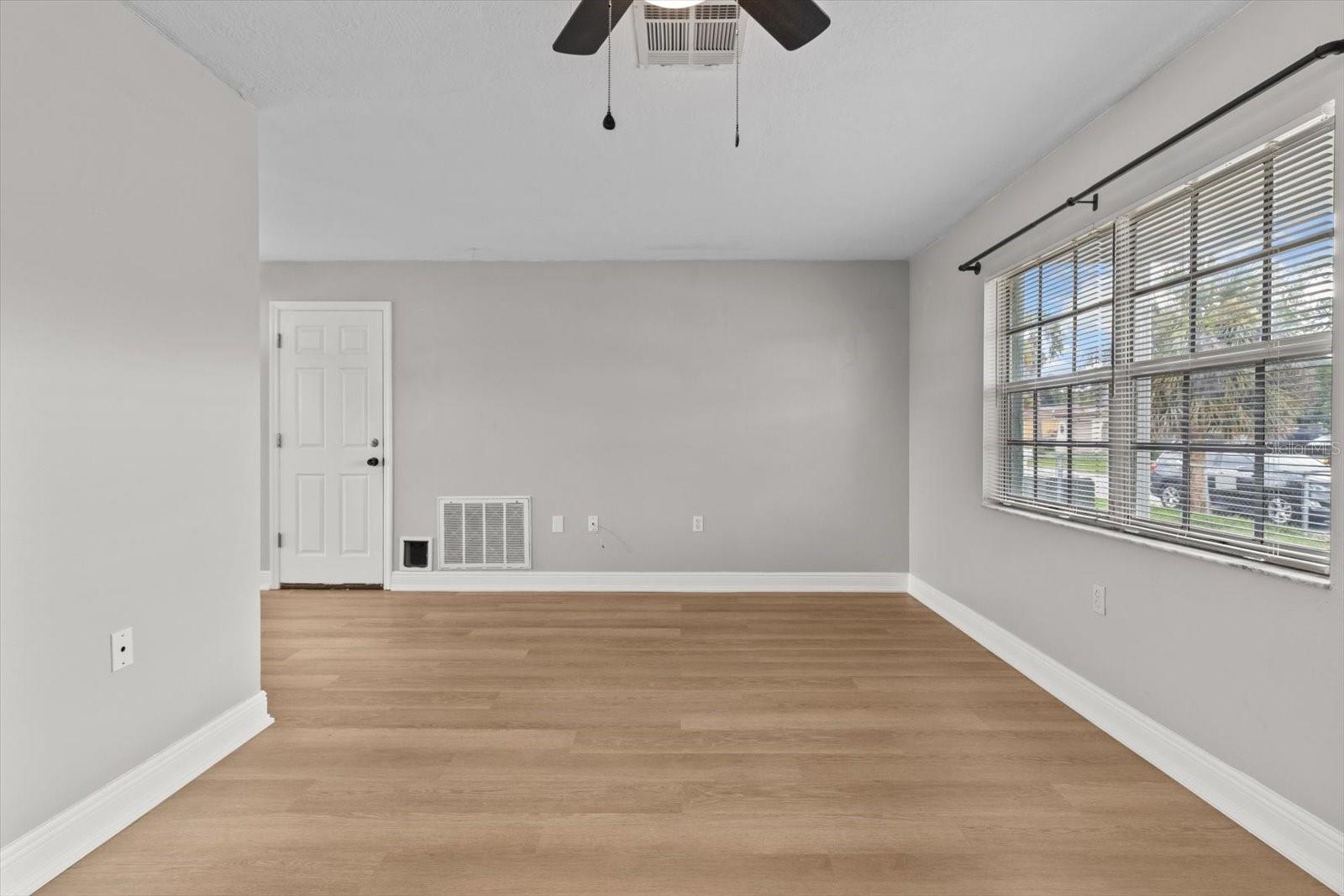 Large front-facing window brings in natural light and highlights the clean, neutral palette.