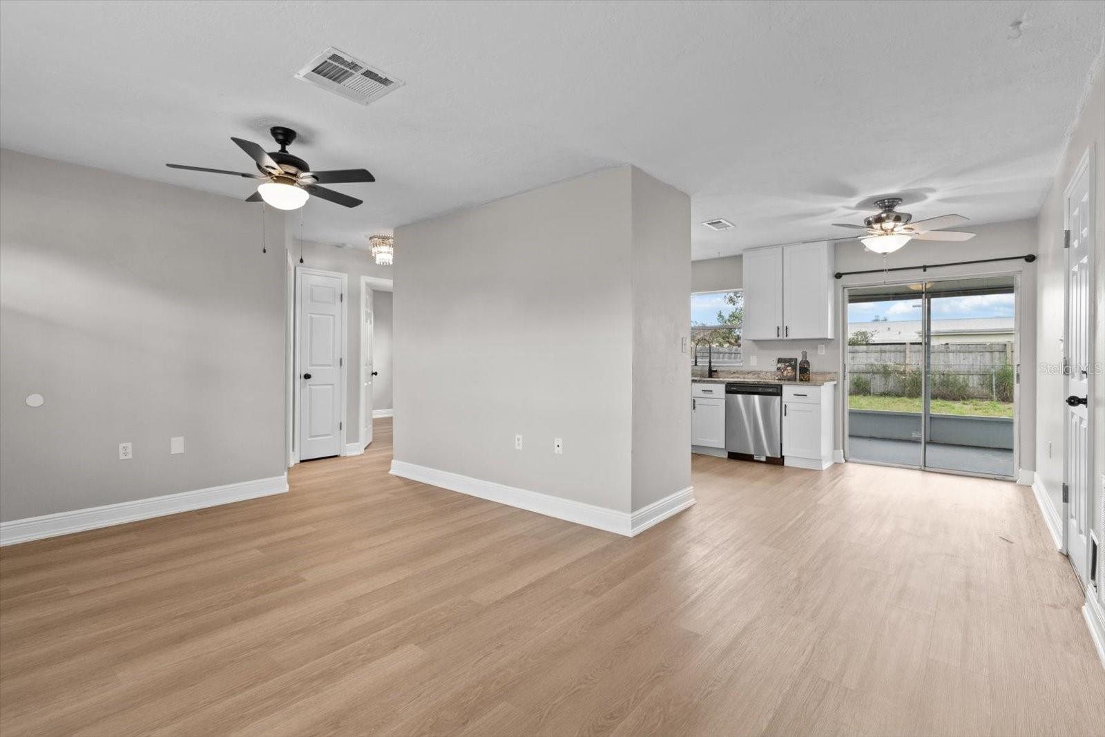 Spacious common area with clear view from the living room to the backyard.