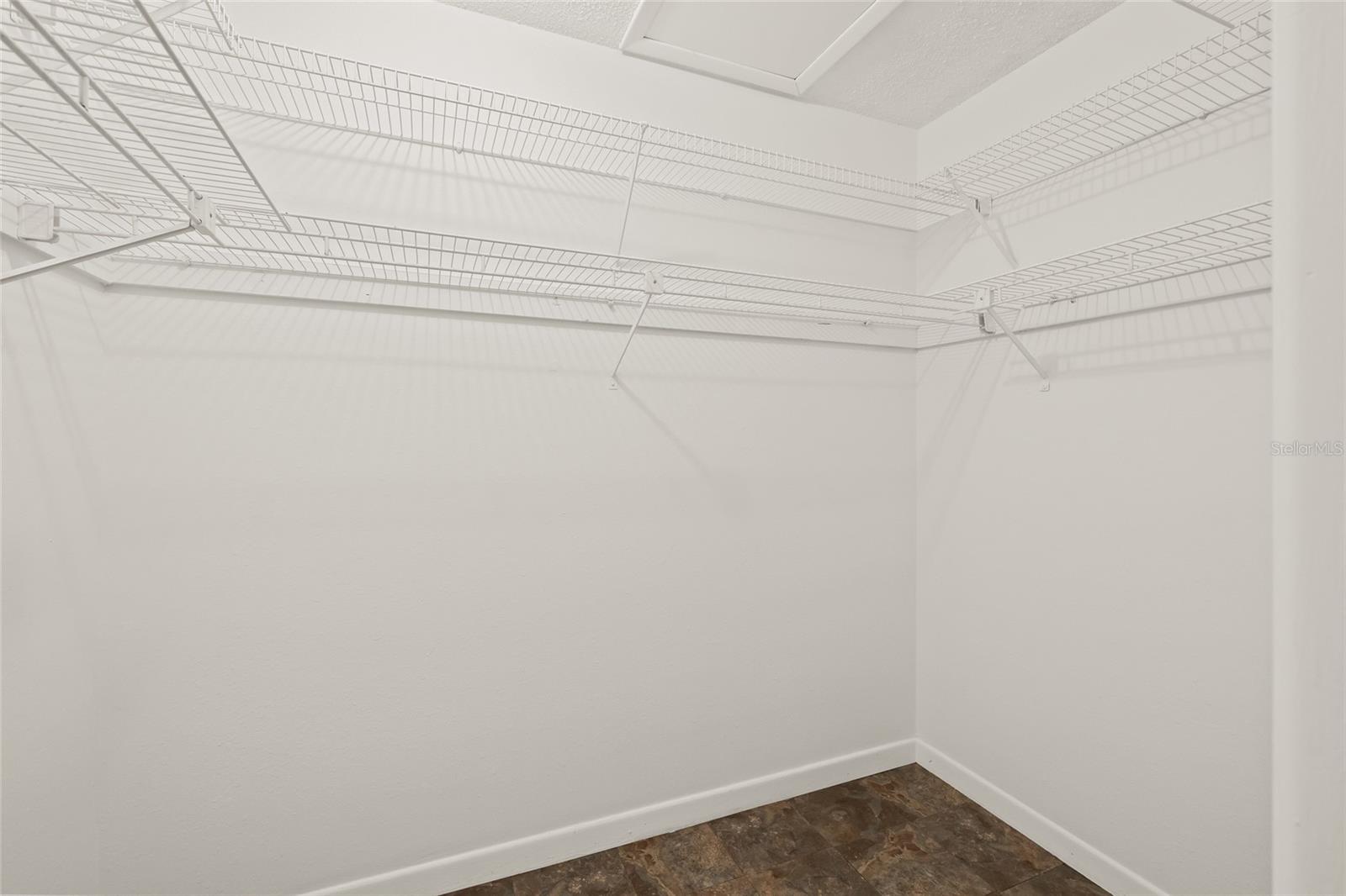 Primary bedroom walk in closet
