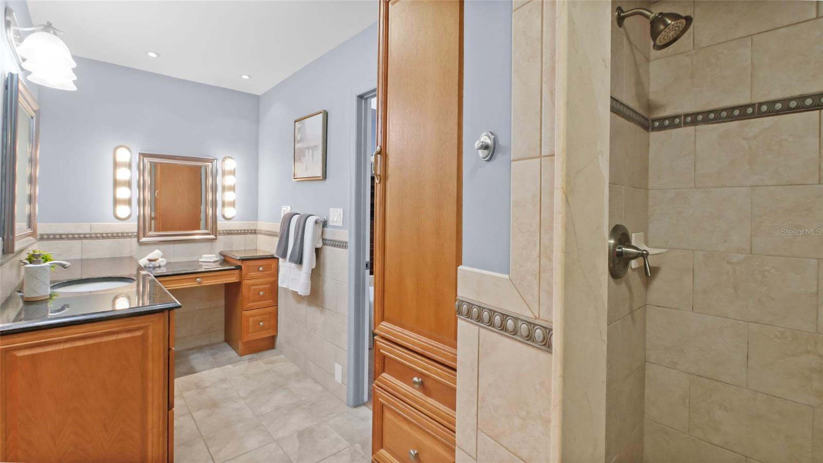 Primary bath with 3 vanity stations, 2 sinks and walk-in shower