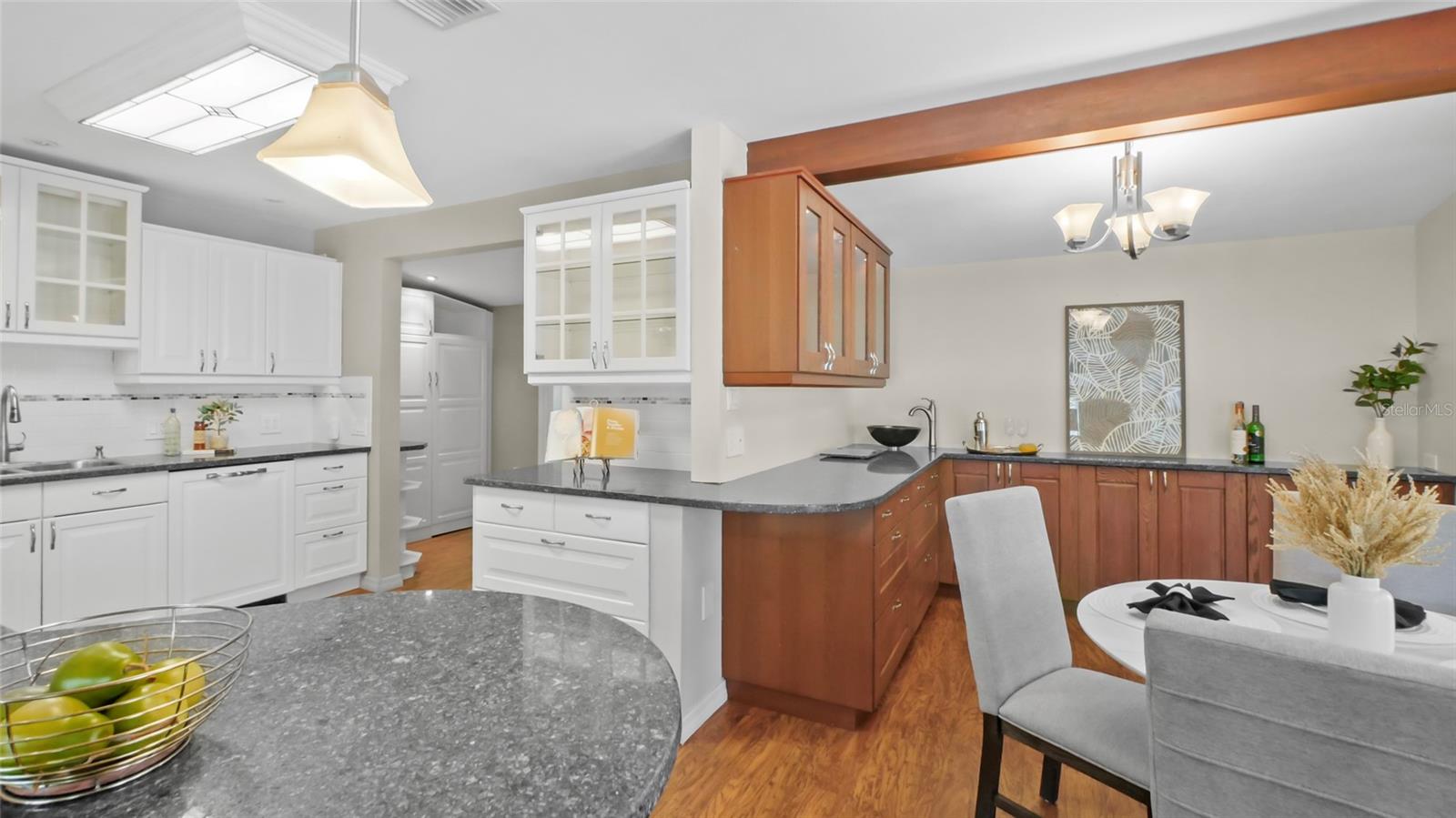 Large kitchen with separate serving area and wet bar
