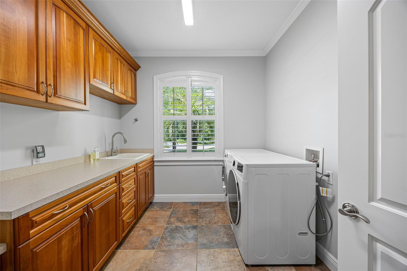 Inside laundry room with tons of cabinets!