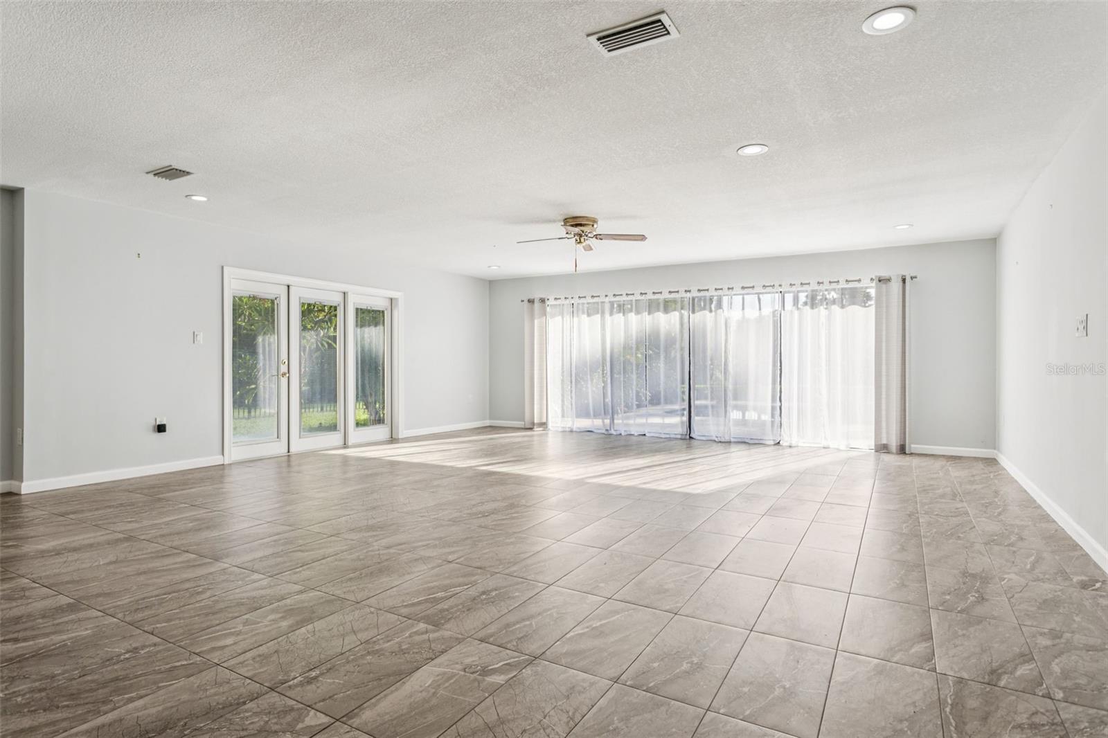 Kitchen opens to family room with views of the pool and lake.