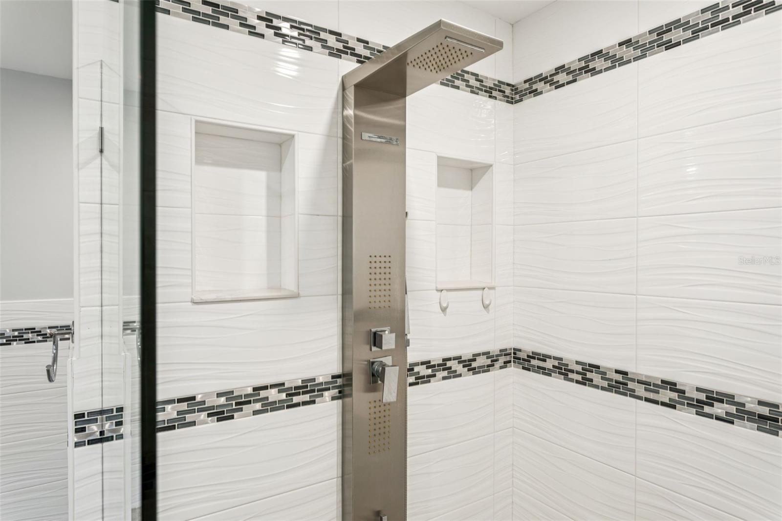 Seamless walk in shower with mulitple water options.