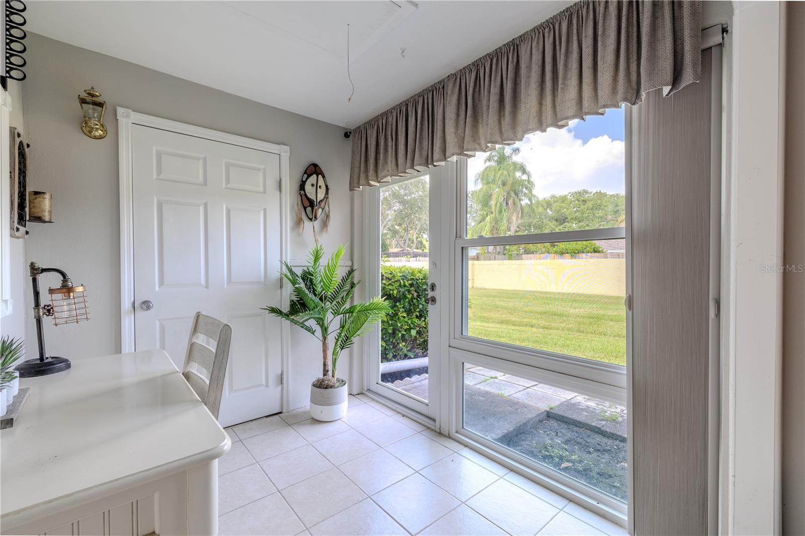 Neutral tile flooring and soft wall tones in the Florida room create a calm, airy feel. Whether you're starting your morning with coffee or winding down with a book, this peaceful space adds valuable flexibility to the home.