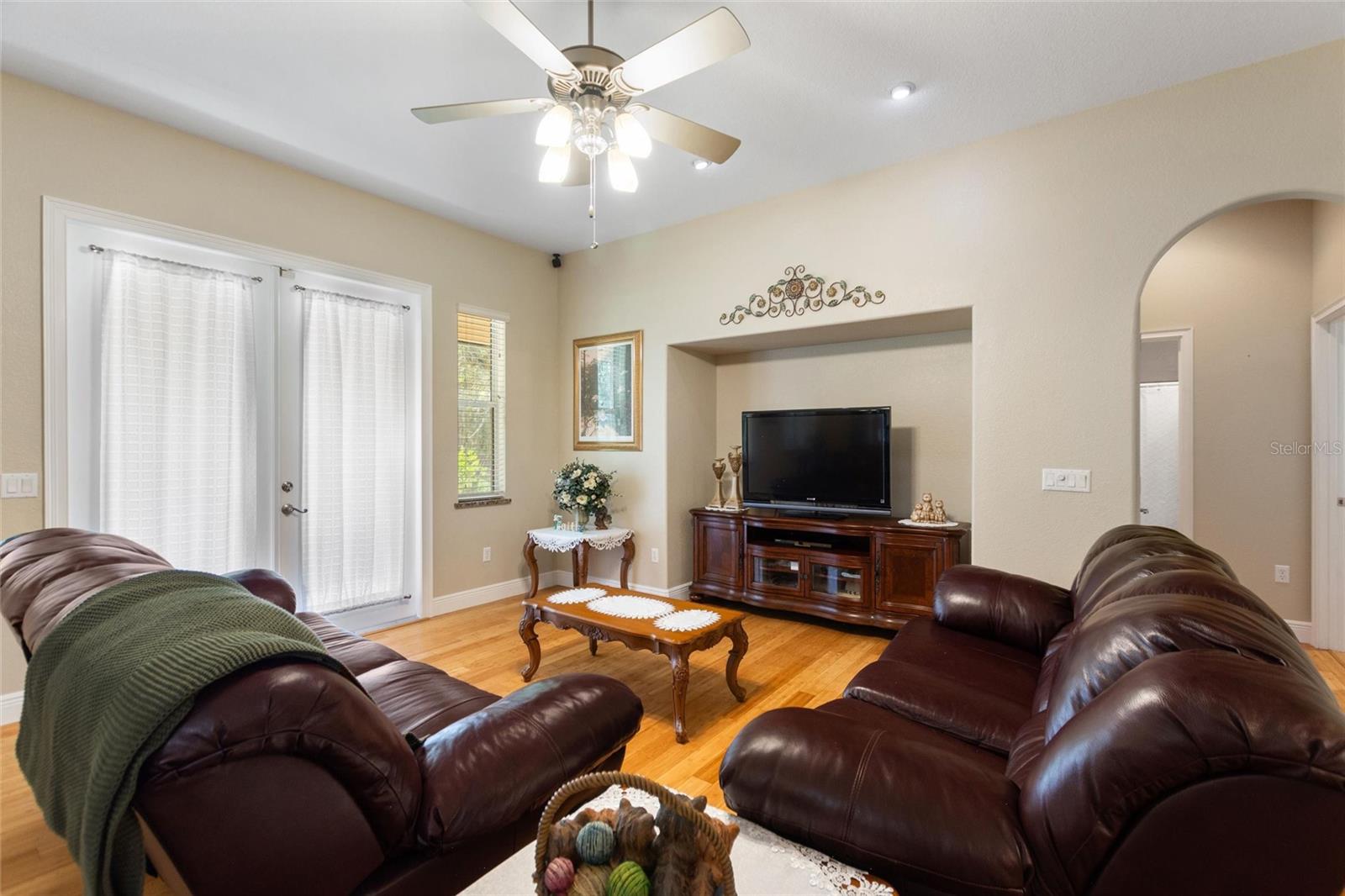 Living room with french doors leading to back screened lanai.