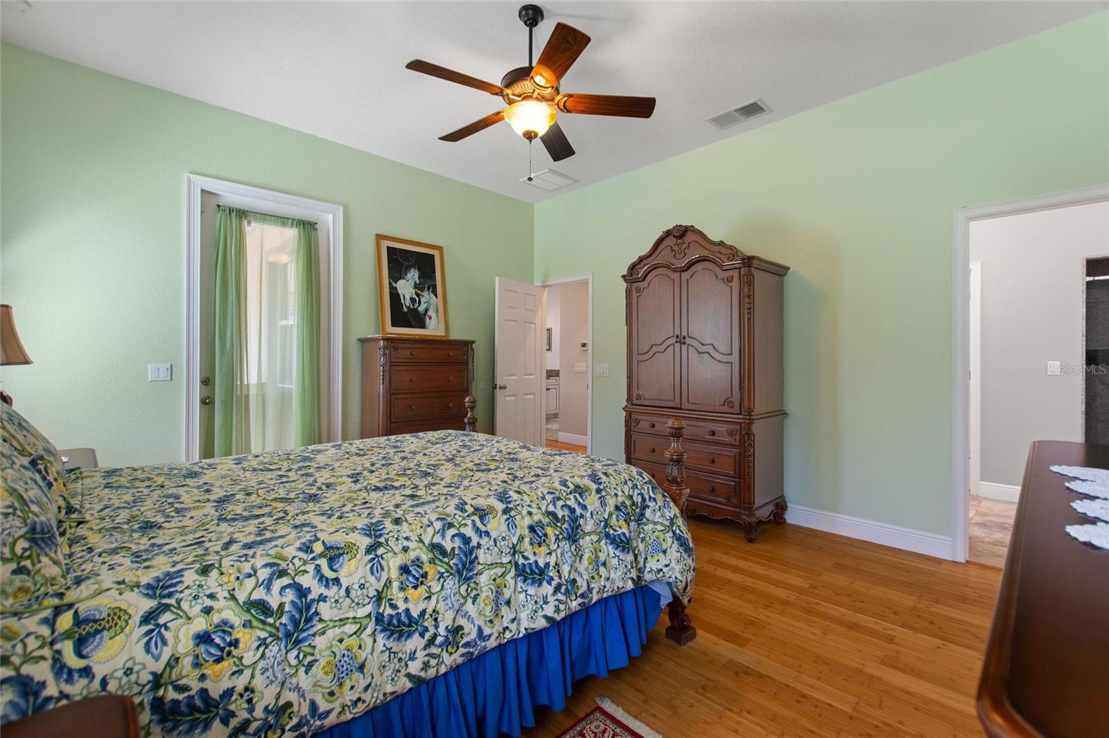 Master bedroom with door leading to back screened in lanai.